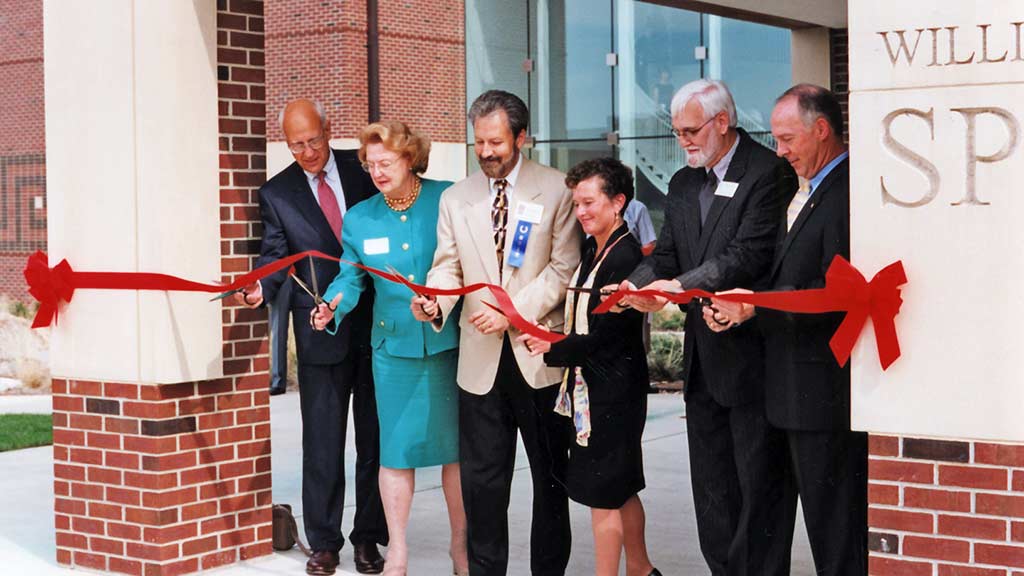 University officials cut red ribbon at entrance