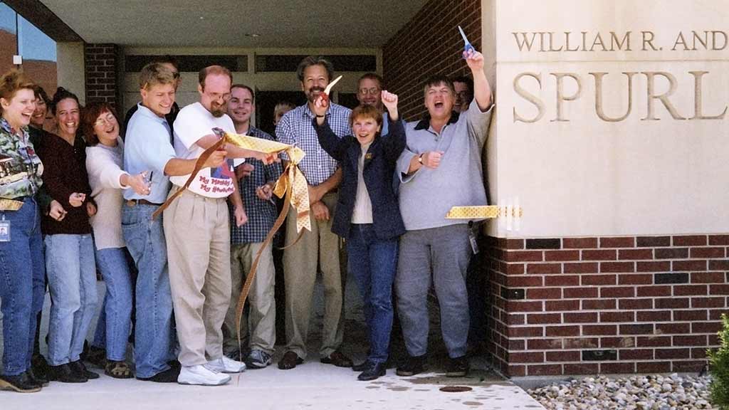 Museum staff excitedly cut unofficial ribbon at entrance