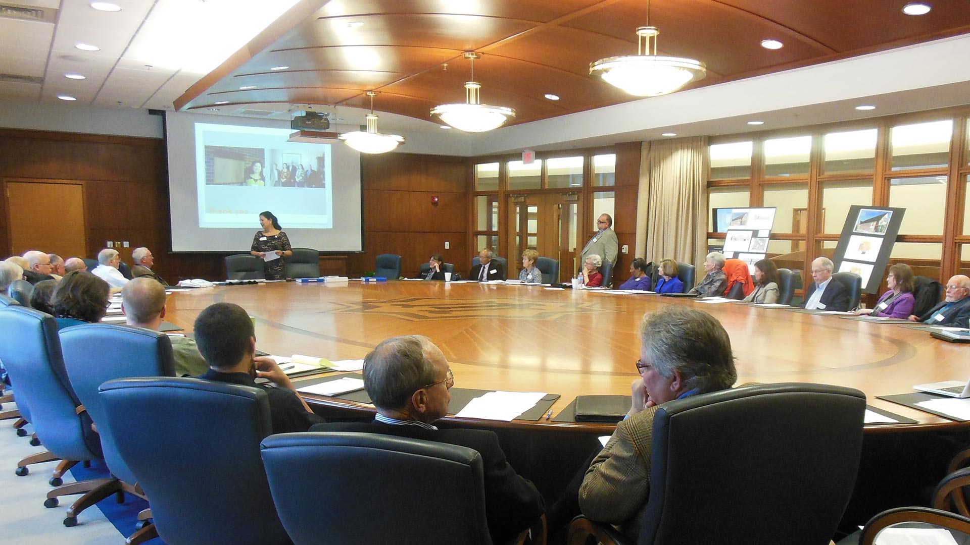 Museum board meeting around large conference table