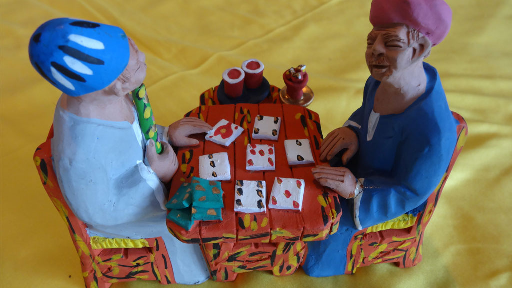 a statue of twp men playing cards