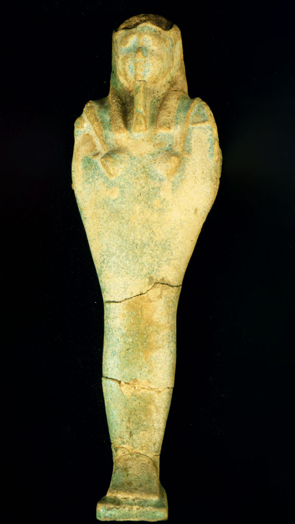 green and yellow stone carving of a mummy