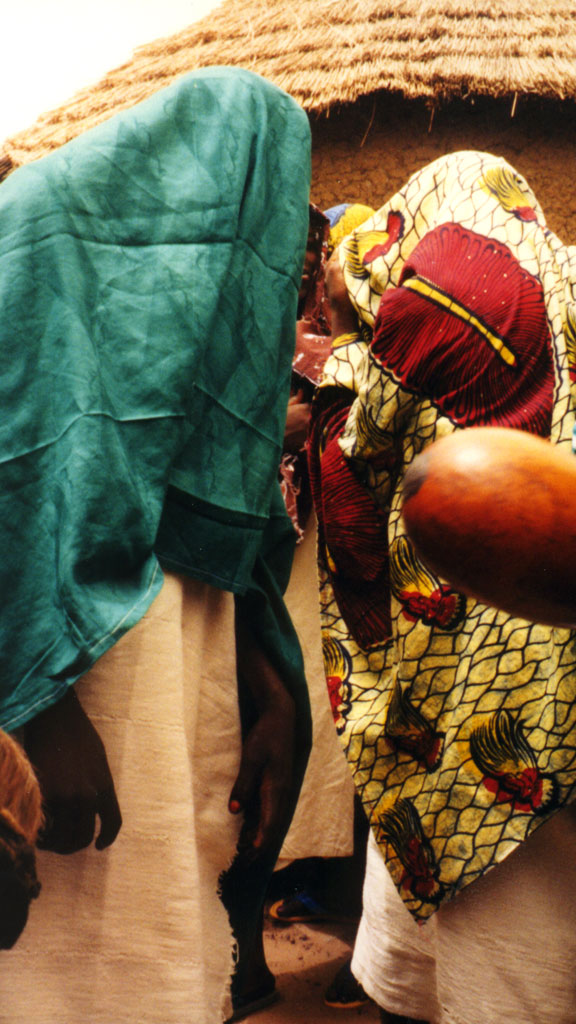 two brides covered by cloths in the village