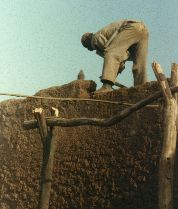 man standing on flat roof