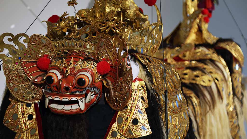 large dance costume with animal hair and a mask with teeth